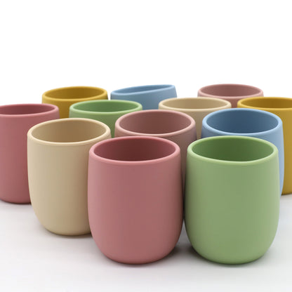 Mini baby silicone water cup, easy-to-grip training cup, safe soft silicone, BPA-free, toddler open sip design.